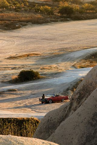 Old car on an empty desert road — photo by Ahmet on Pexels