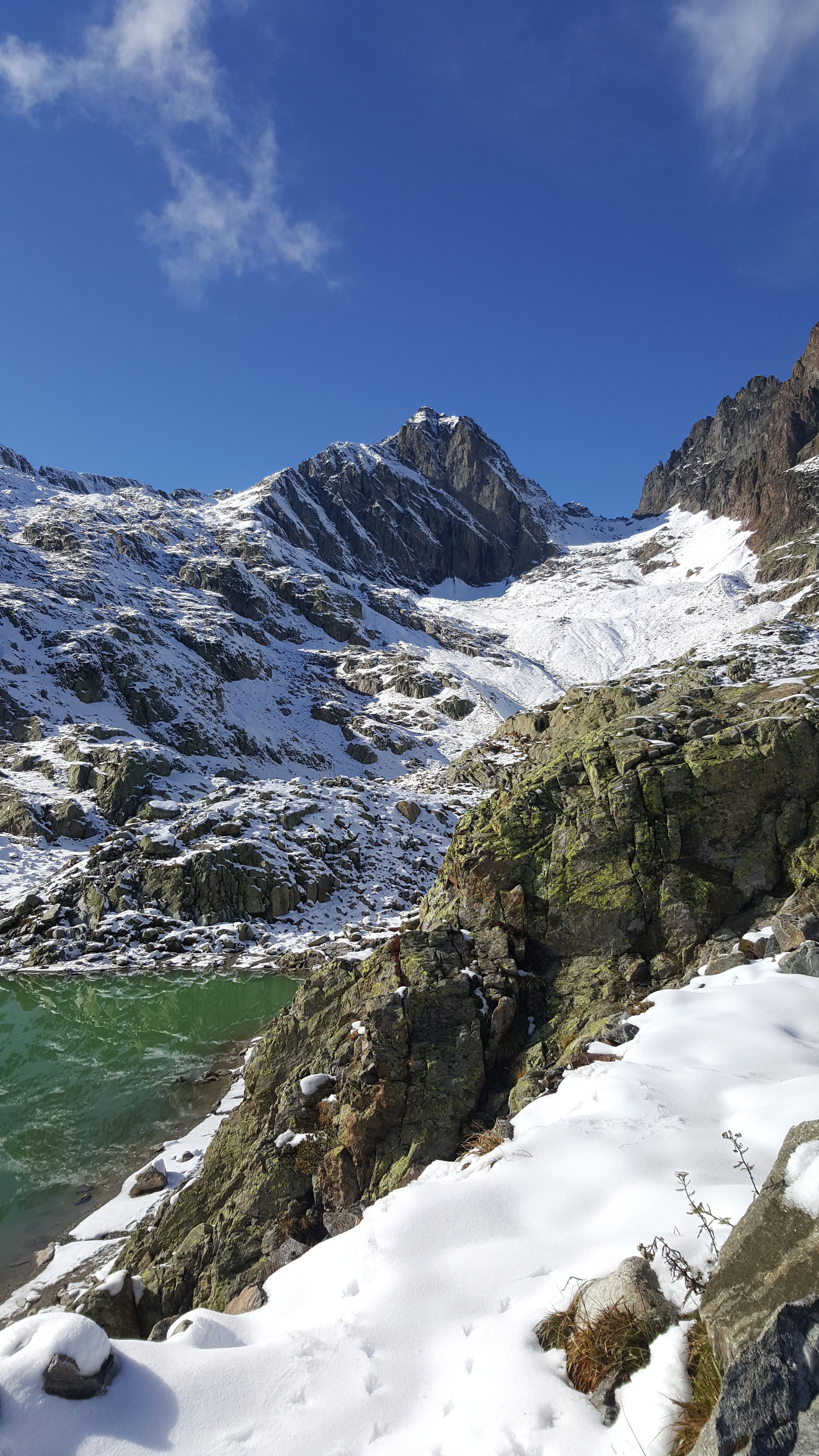 Scenic view of snow-covered mountains under clear blue sky, perfect travel destination.