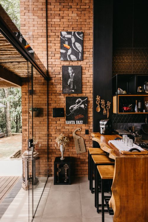 Free Cozy cafe with a brick wall featuring jazz-themed art in Espírito Santo, Brazil. Stock Photo