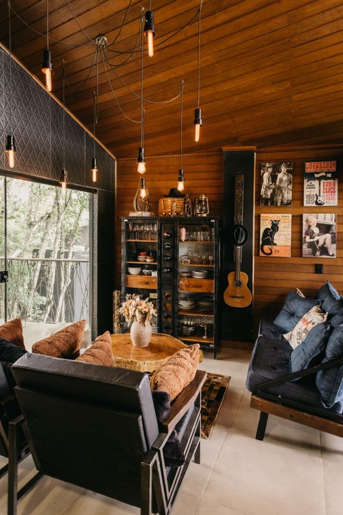 Free Rustic living room with guitar decor and cozy ambiance in Espírito Santo, Brazil. Stock Photo