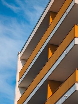 A modern apartment building showing geometric architectural design and bright colors.