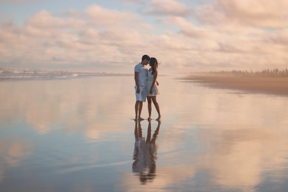 Free Photo Of Couple Standing On Water Stock Photo