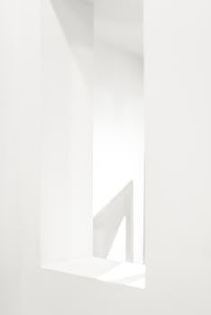 A minimalist abstract white interior space showcasing clean lines and modern architecture.