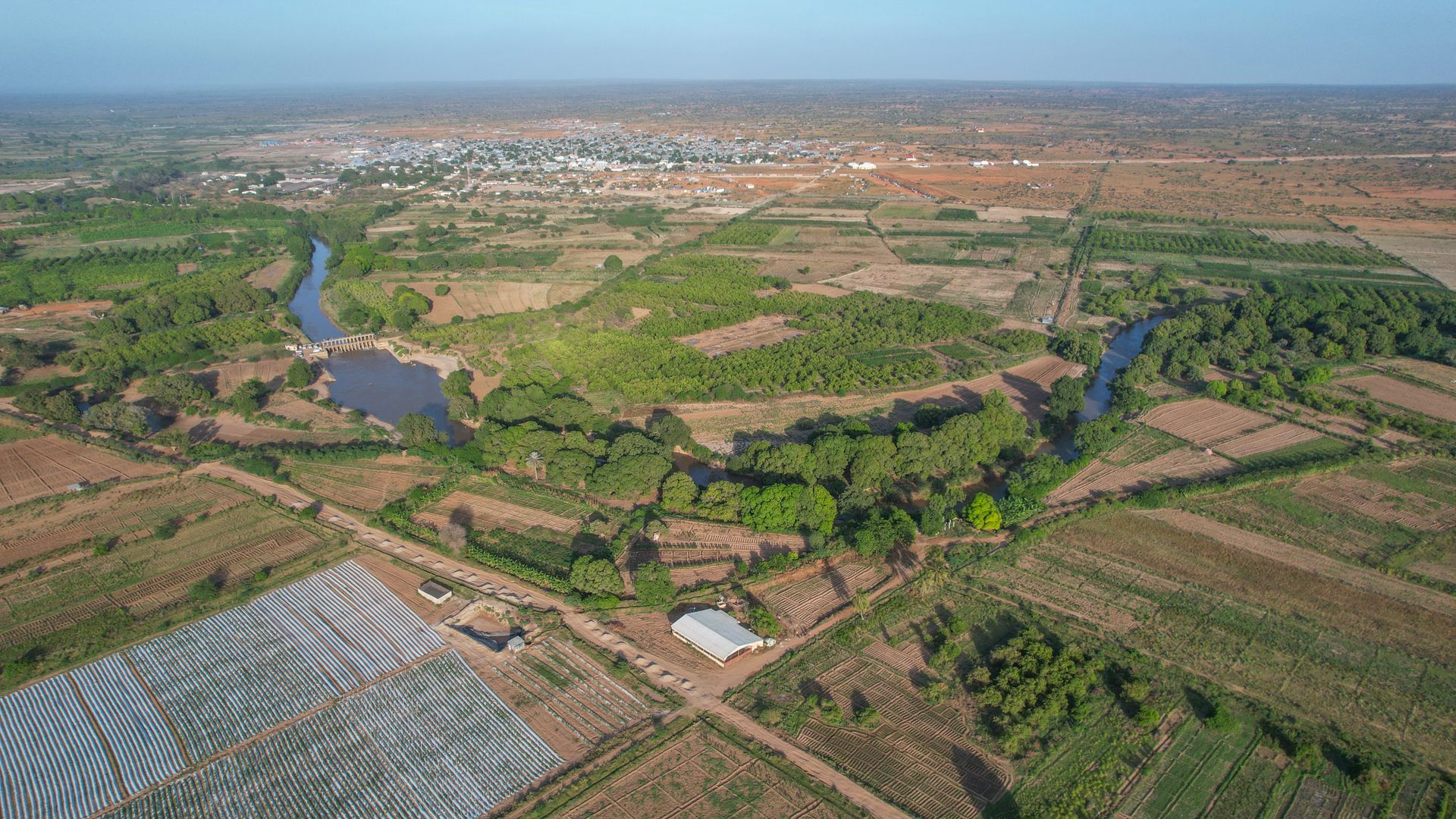 A scenic aerial view showcasing the agricultural landscape and river in Balcad, Somalia.