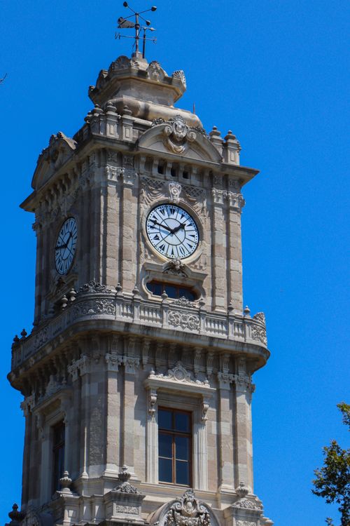 Free Ornate Dolmabahçe Clock Tower against a clear blue sky in Istanbul, Turkey. Stock Photo