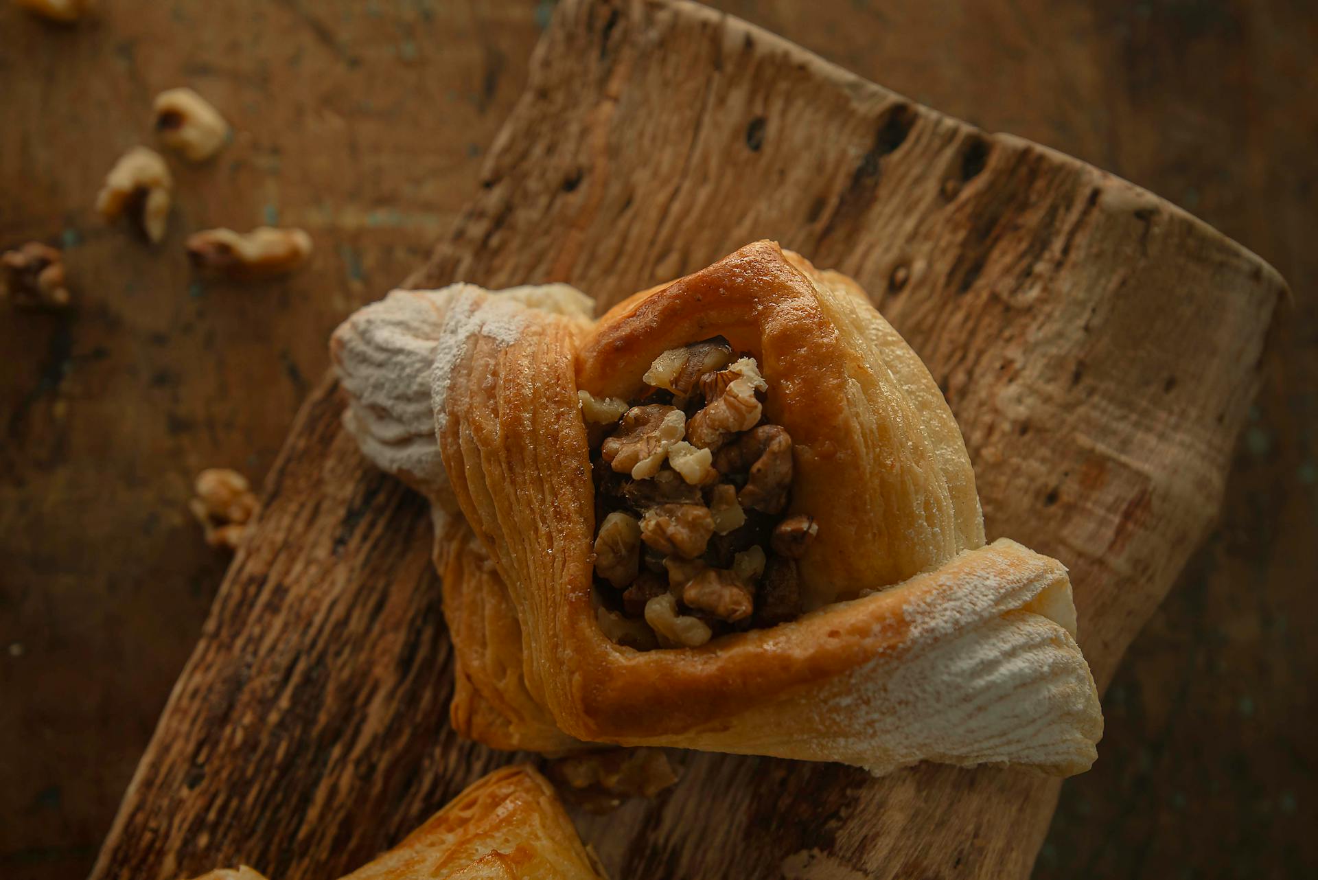 Appetizing walnut pastry placed on rustic wooden board, perfect for food blogs.