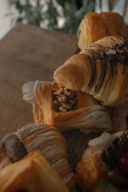 Free Close-up of a variety of freshly baked pastries on a wooden table. Stock Photo