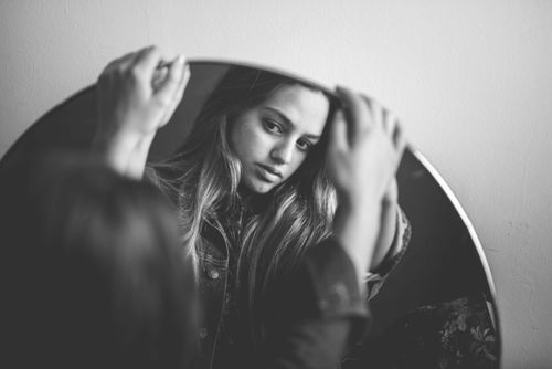 Free Elegant black and white portrait of a woman reflecting in a mirror. Stock Photo