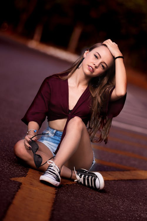 Photo of Woman Sitting on Pavement