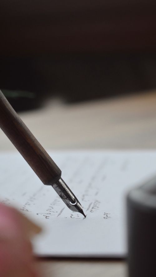 Close up of fountain pen writing on paper