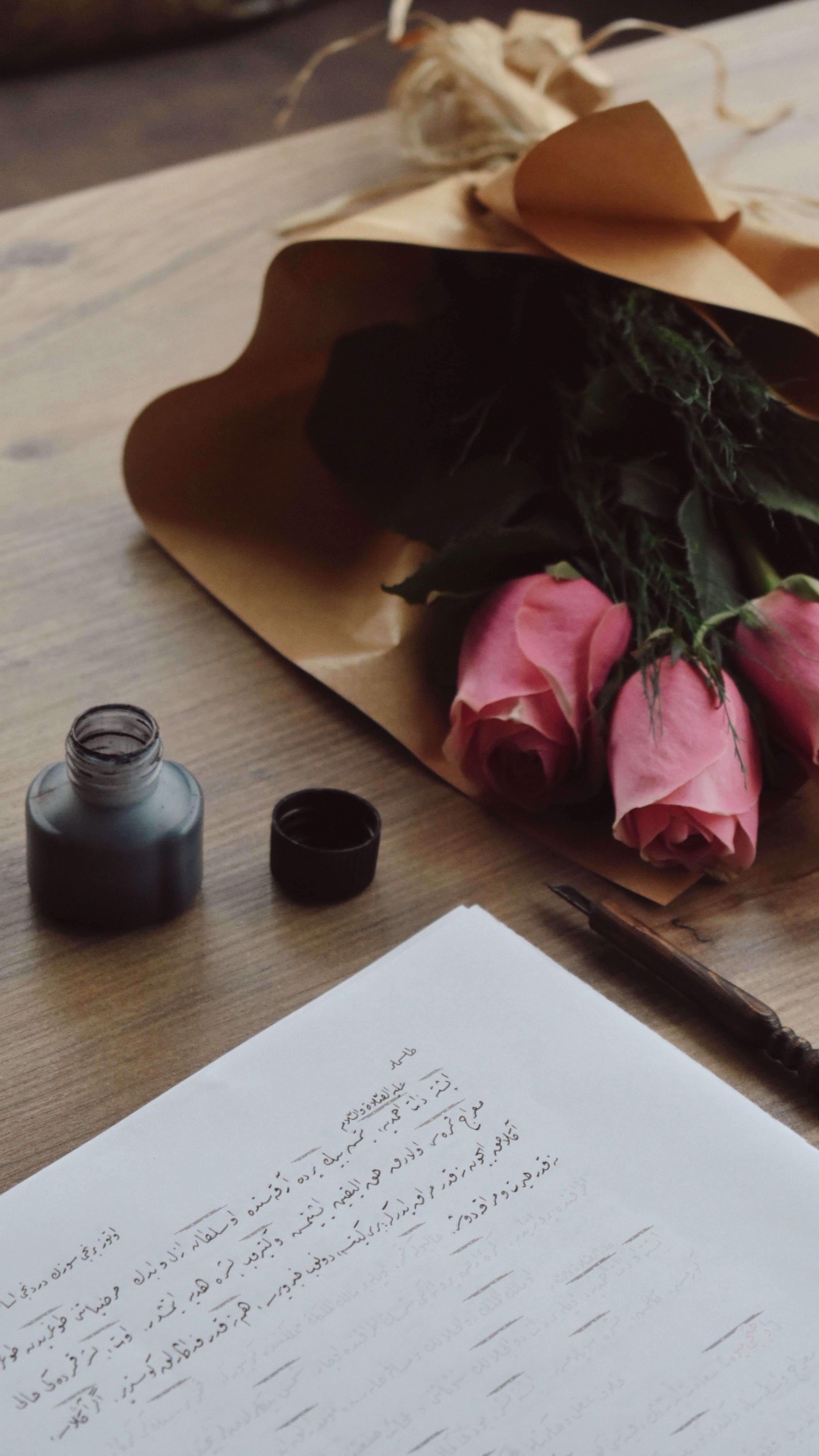 Pink roses with ink and calligraphy, exuding timeless elegance and romance.