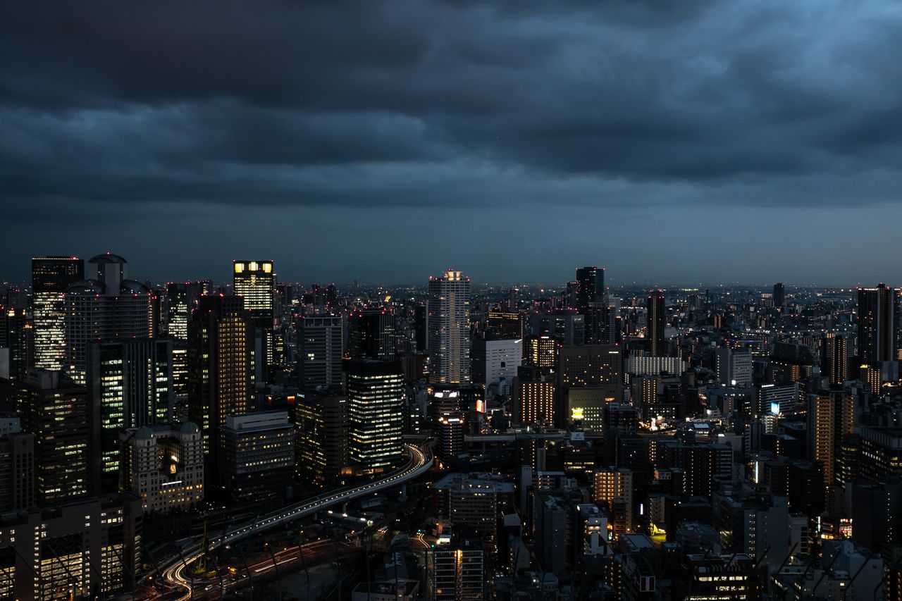dramatic osaka skyline at twilight showcasing illuminated skyscrapers