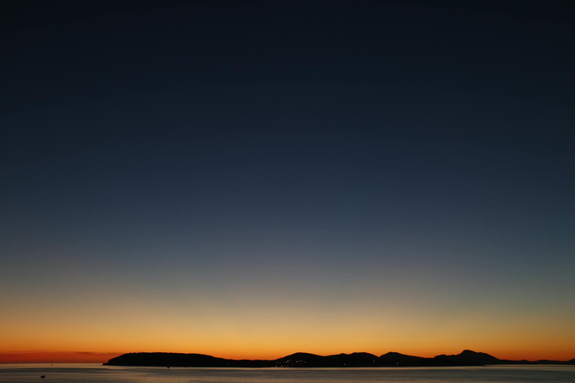 Beautiful sunset over an island silhouette with a colorful sky, perfect for nature and travel themes.