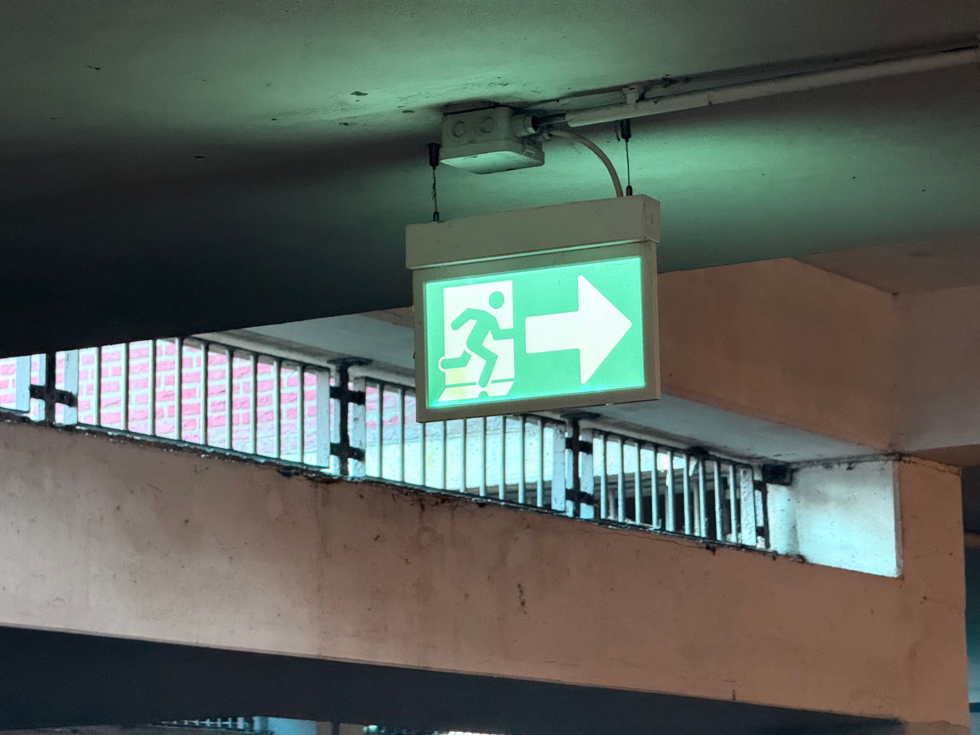 Emergency Exit Sign in Parking Garage · Free Stock Photo