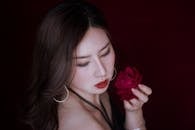 High Angle Photo of Woman Holding Red Rose