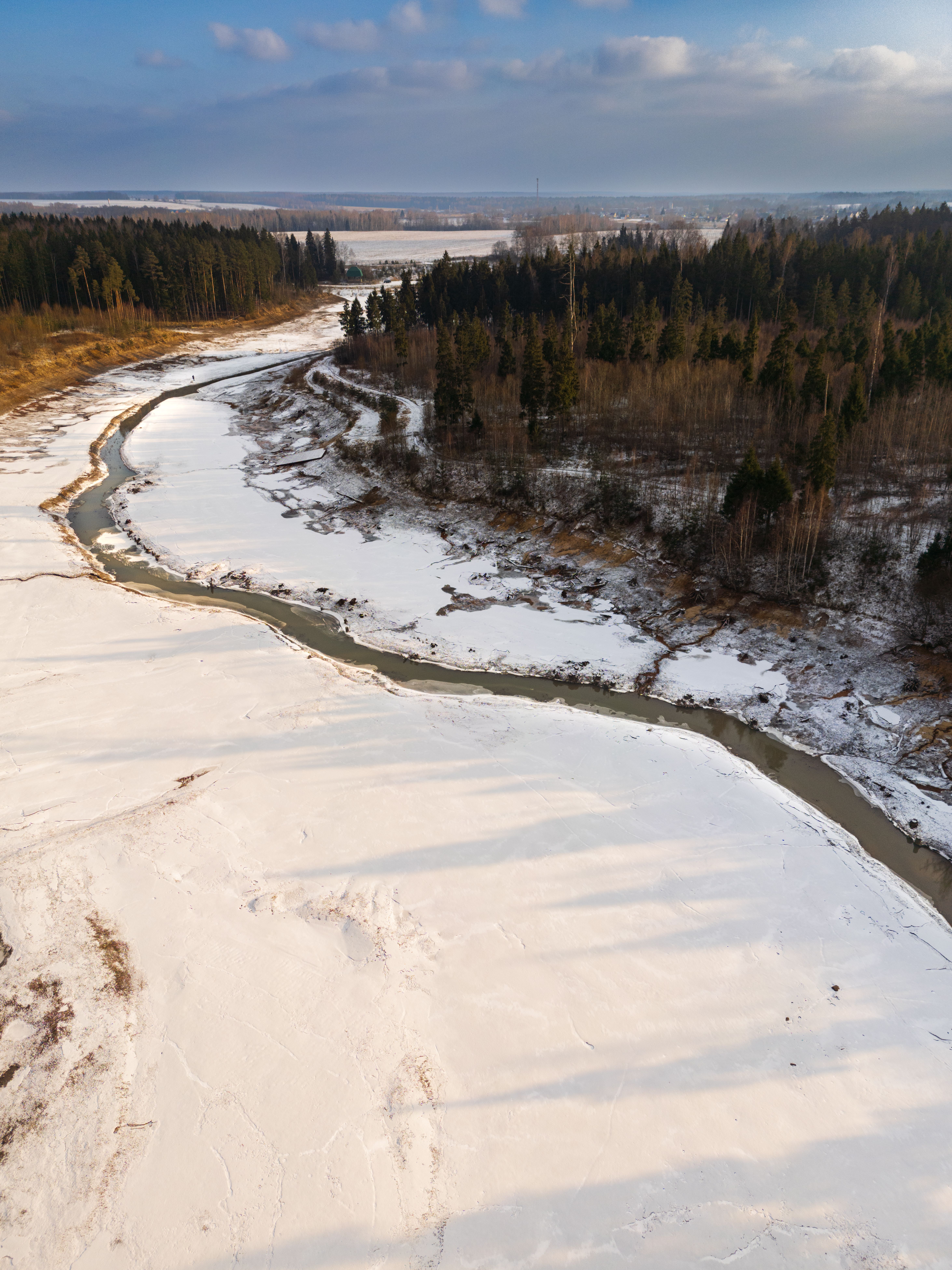 Aerial View of a Snow-Covered Riverbend in Winter · Free Stock Photo