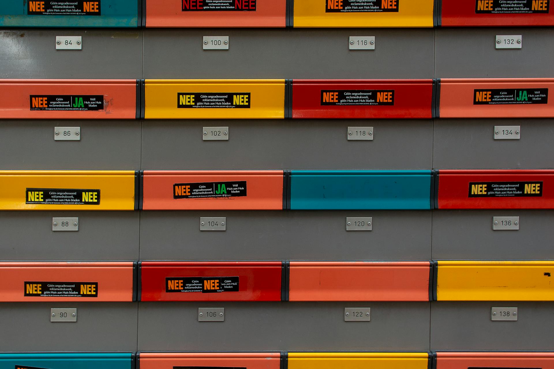 Colorful mailboxes arranged in neat rows with numbered labels.