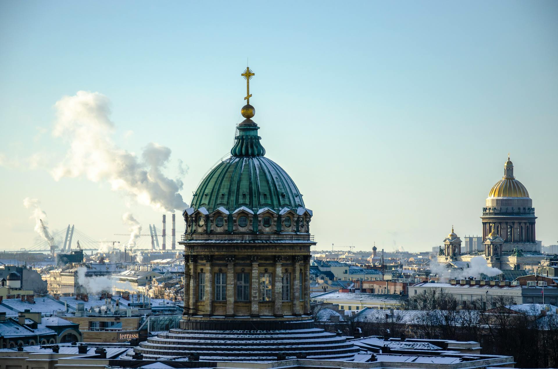 Scenic winter view of St. Isaac's Cathedral in St. Petersburg with snow and clear sky.