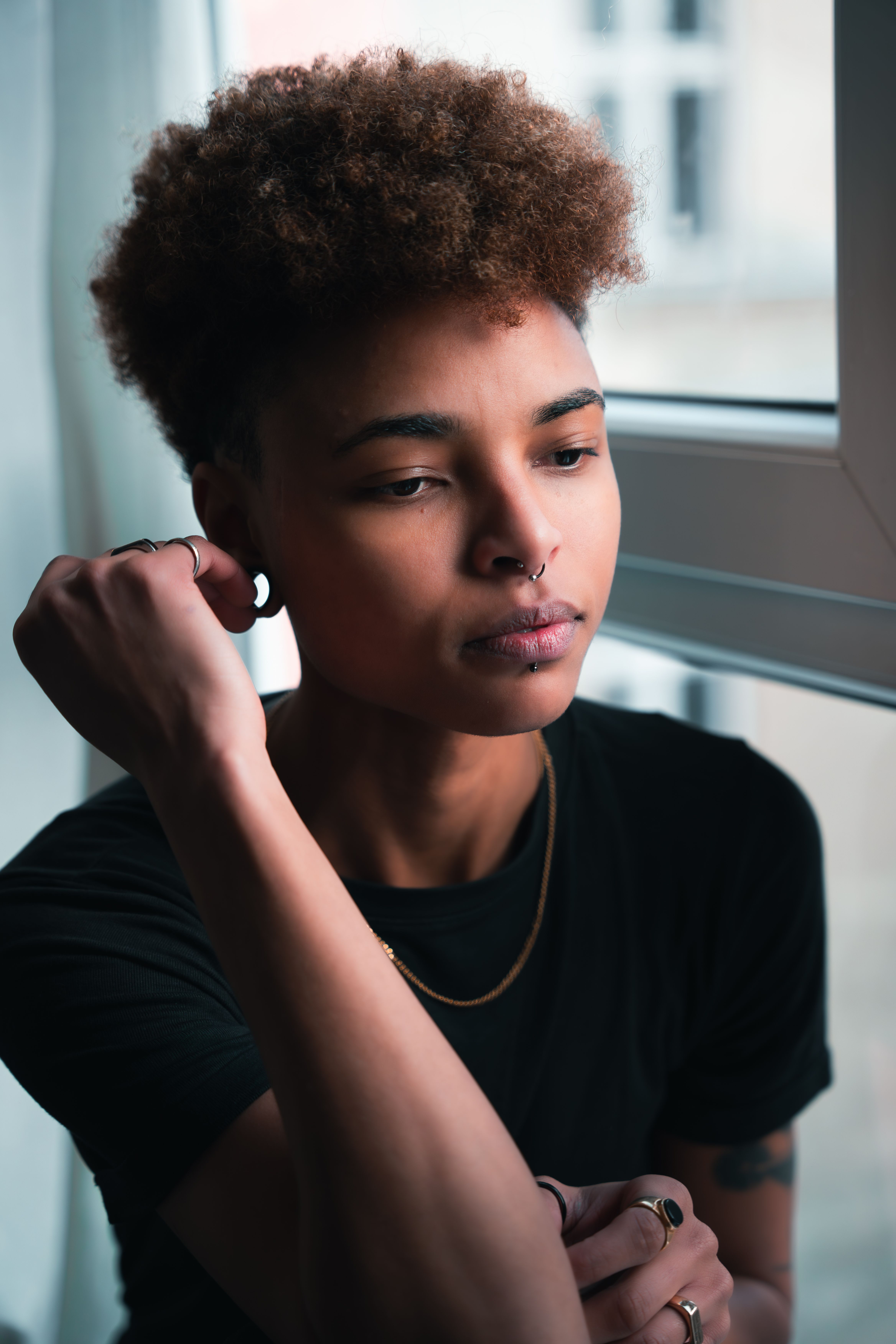 Contemplative Young Woman by Berlin Window · Free Stock Photo