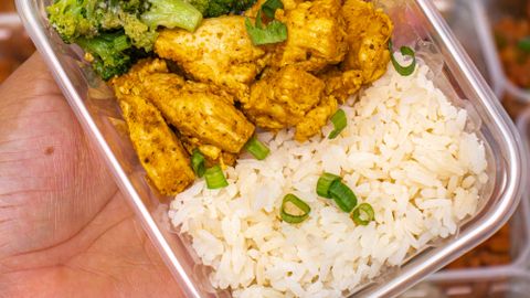 Meal prep featuring chicken, broccoli, and rice in a container, perfect for healthy eating on-the-go.