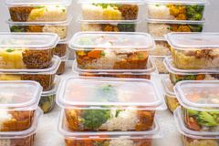 Organized meal prep containers filled with rice and vegetables for healthy eating.