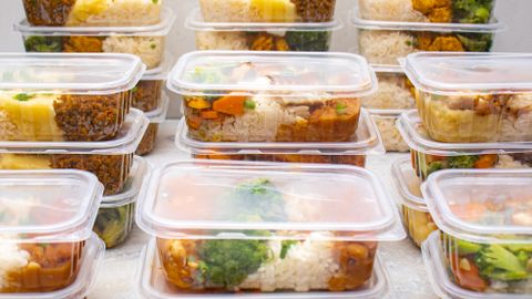 Organized meal prep containers filled with rice and vegetables for healthy eating.