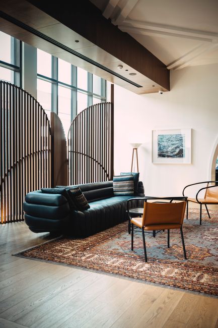 Modern living room with stylish furniture, natural light, and elegant decor.