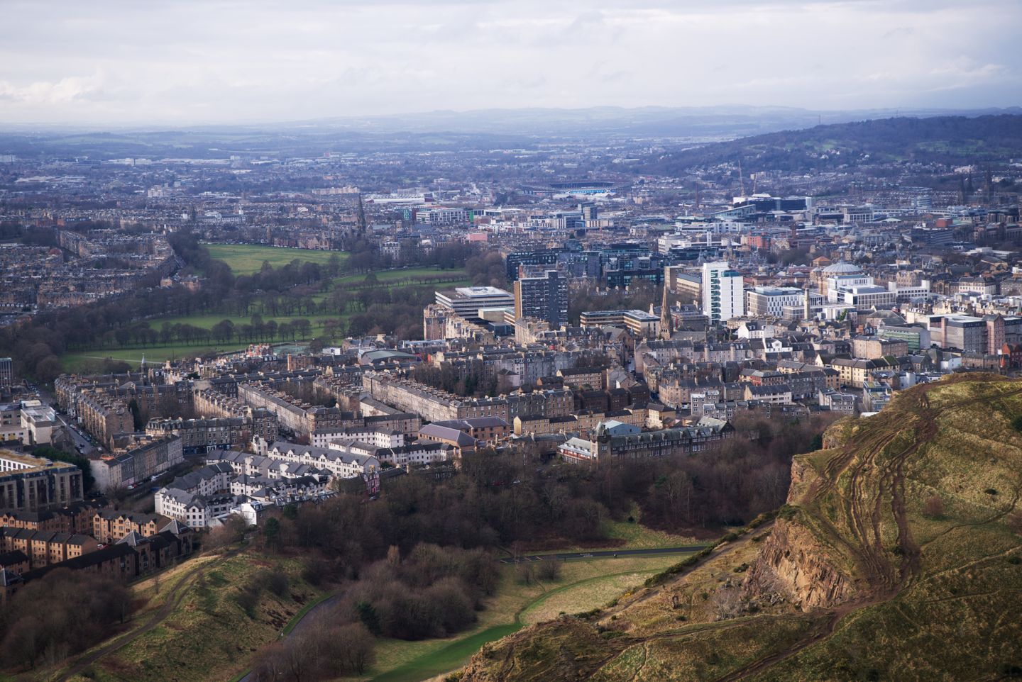 Aerial view of Edinburgh cityscape from Arthur's Seat, showcasing vibrant urban architecture, United Kingdom