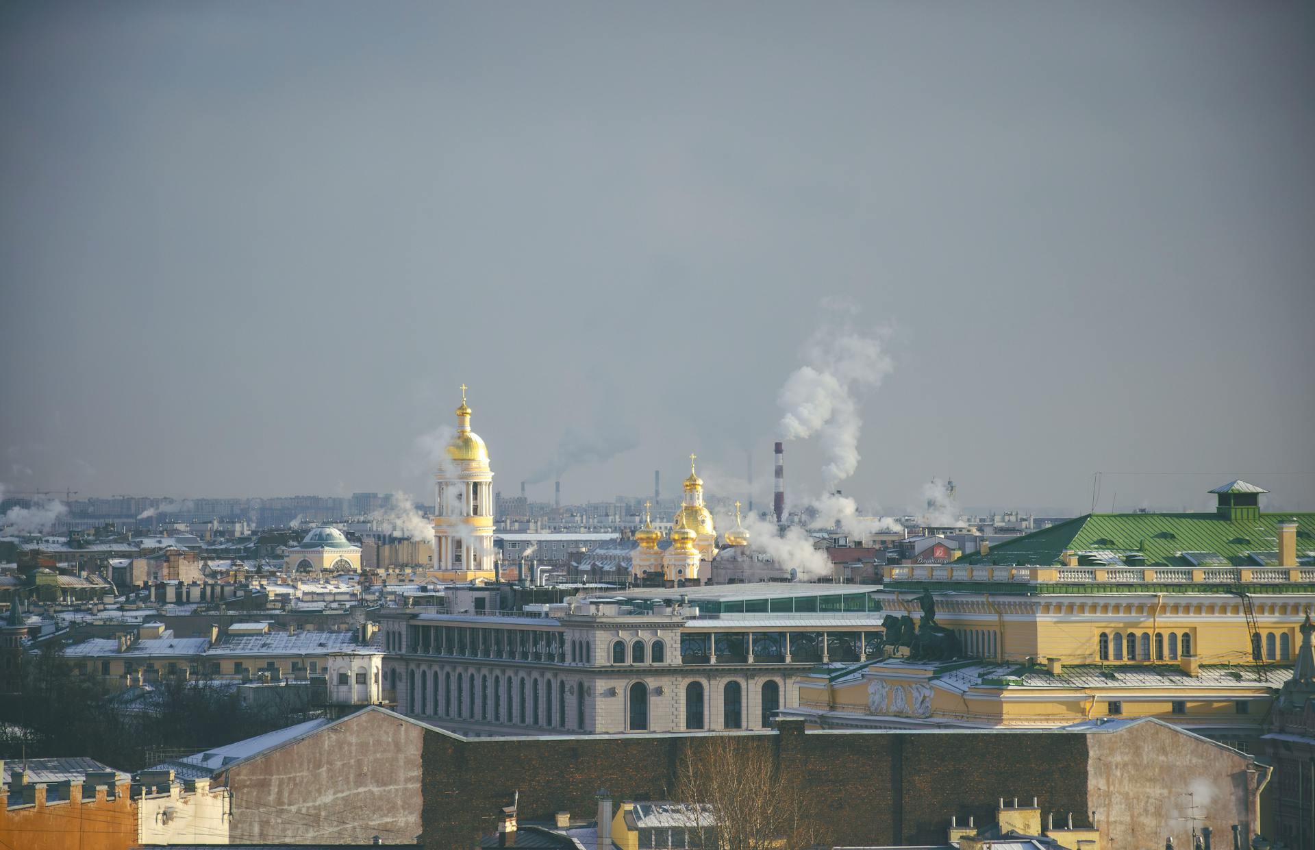 Aerial view of St. Petersburg skyline with iconic golden domes and winter atmosphere.