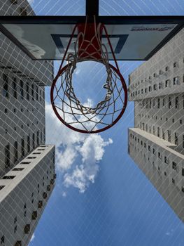 Basketball hoop framed by tall skyscrapers in São Paulo, Brazil on a clear day.