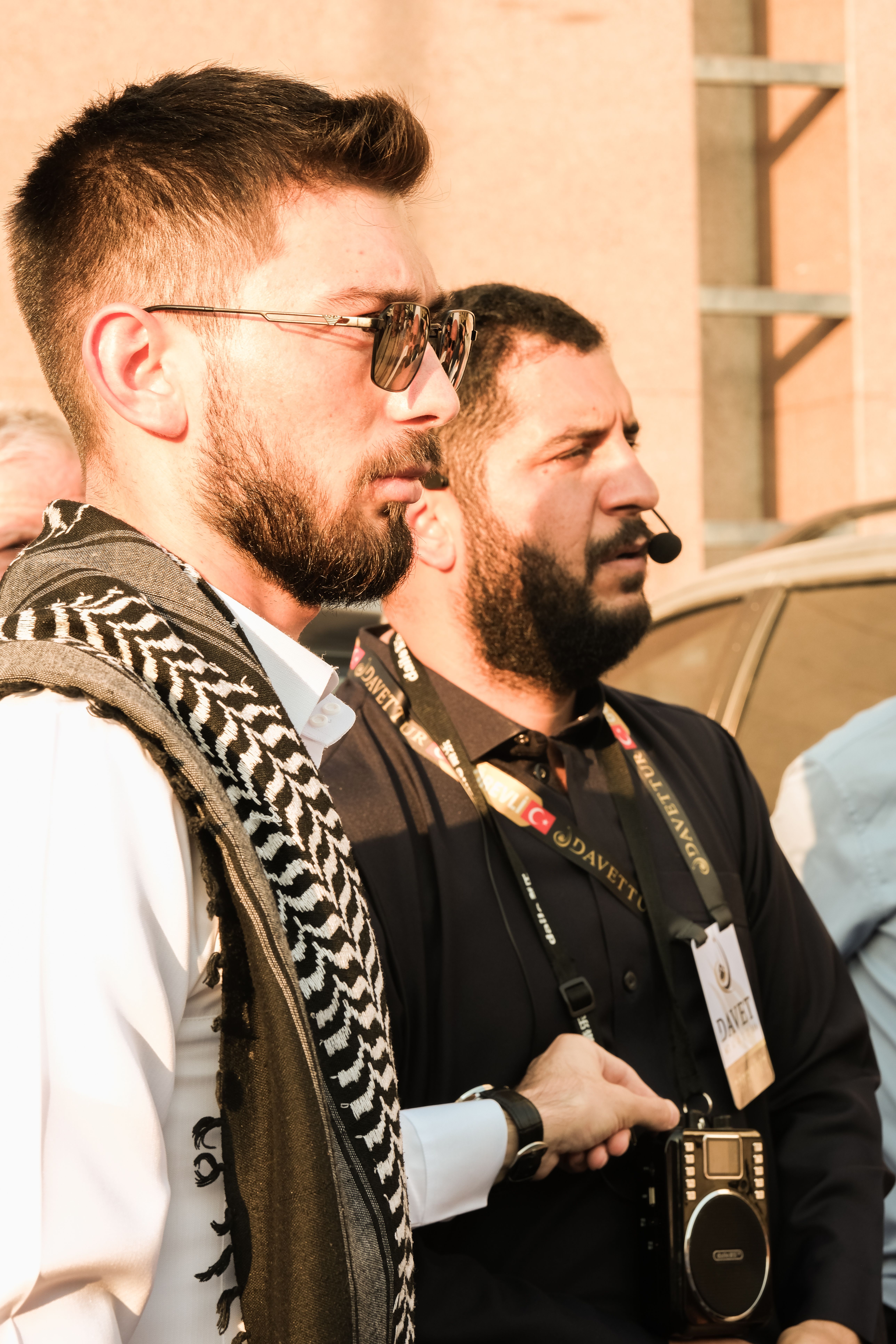 Two men with cameras captured in a vibrant street scene in Saudi Arabia.