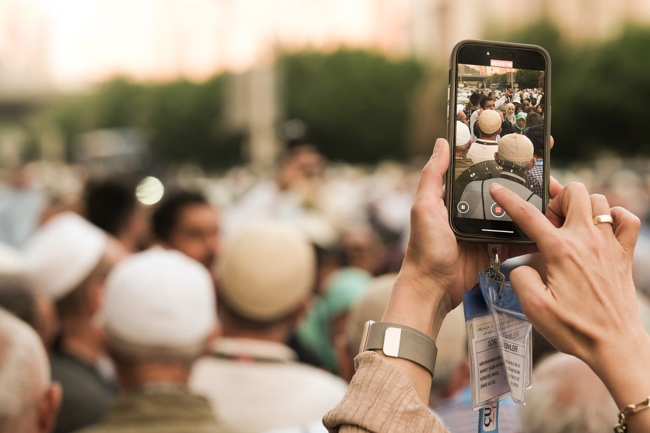 Tourist happily using a smartphone to navigate or communicate in Saudi Arabia