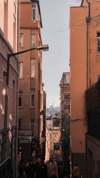 Explore a sunlit alleyway in historic Istanbul with people strolling.