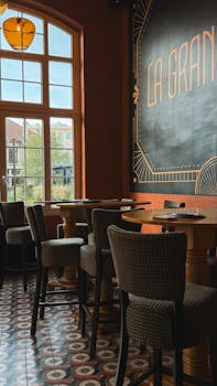 Empty retro café interior with Art Deco design and window view, warm atmosphere.