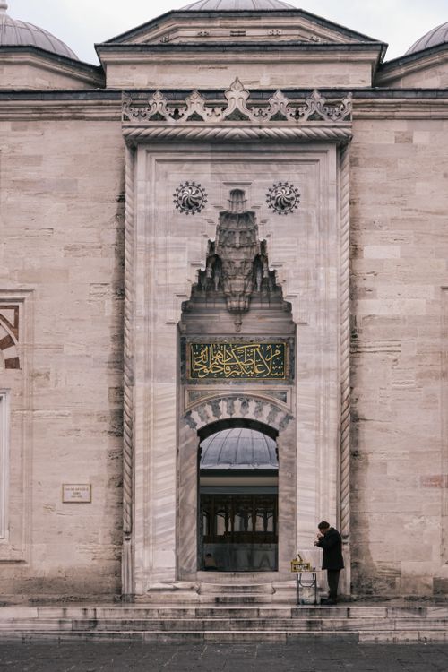 Free Historic Ottoman mosque entrance with intricate archway and calligraphy. Stock Photo