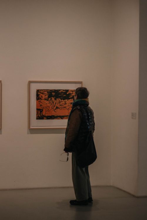 Free Person observes an artwork in Istanbul gallery, capturing serene appreciation moment. Stock Photo