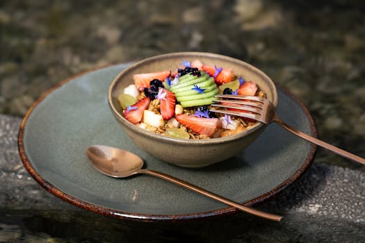 A deliciously colorful fruit and granola bowl set outdoors, perfect for health-conscious food lovers.