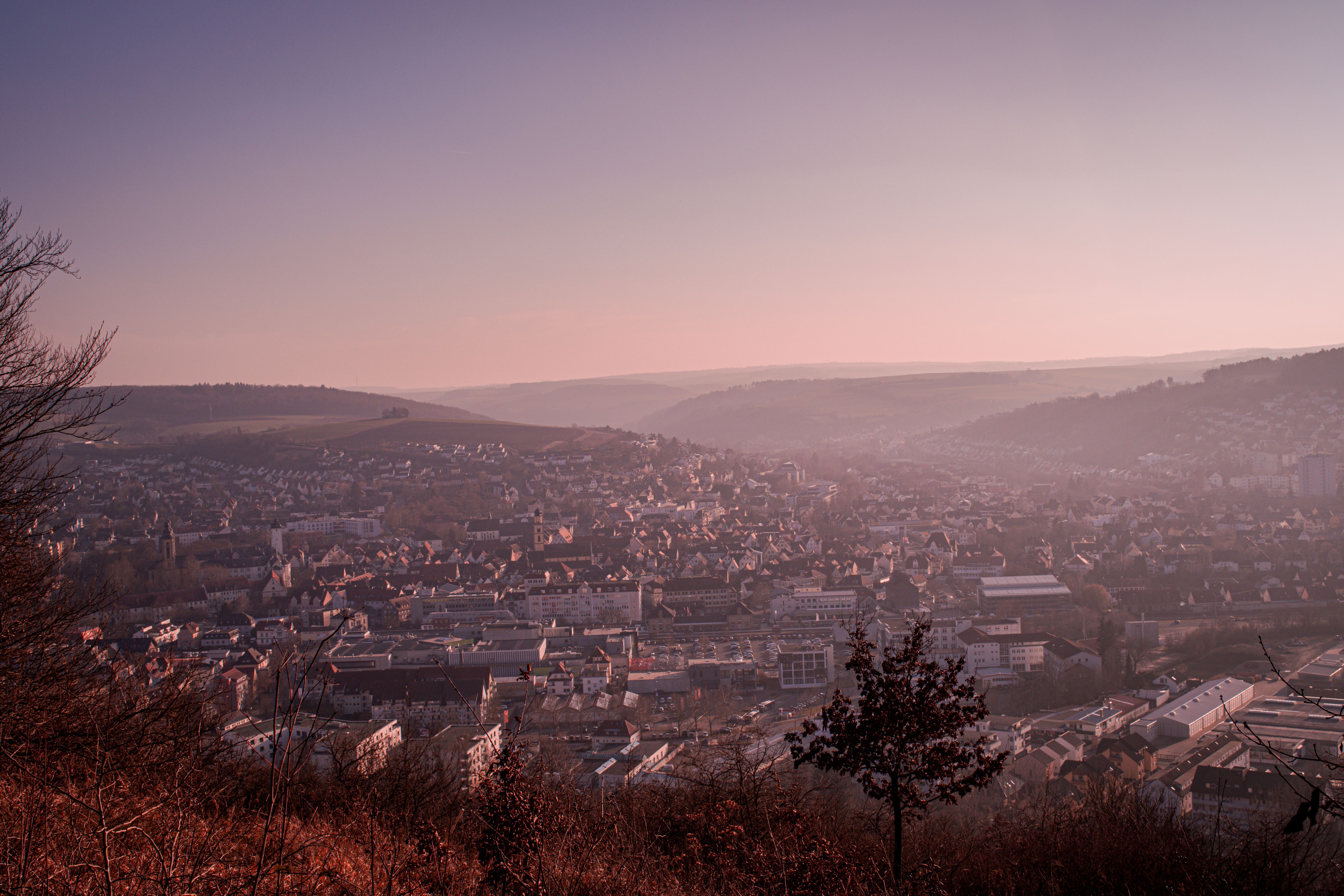 Aerial view of Bad Mergentheim at twilight, showcasing its charming architecture and rolling hills.