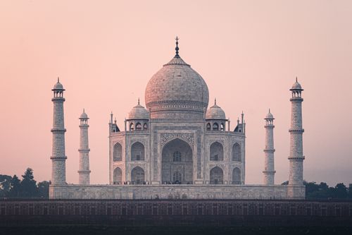 Free Beautiful view of the Taj Mahal at sunrise, showcasing its stunning architecture and historical significance. Stock Photo