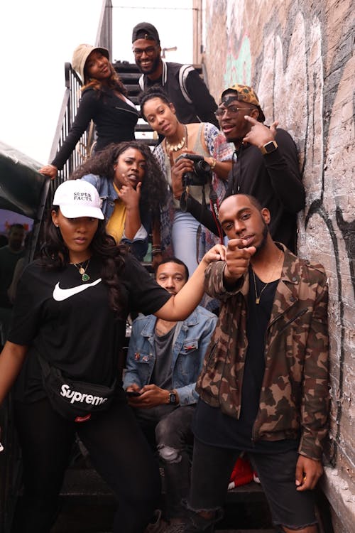 Group Of People Standing On Metal Stairs