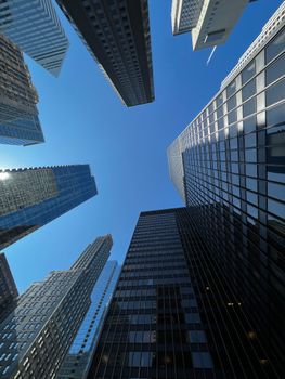 Dramatic view of skyscrapers against a clear blue sky in downtown Chicago.