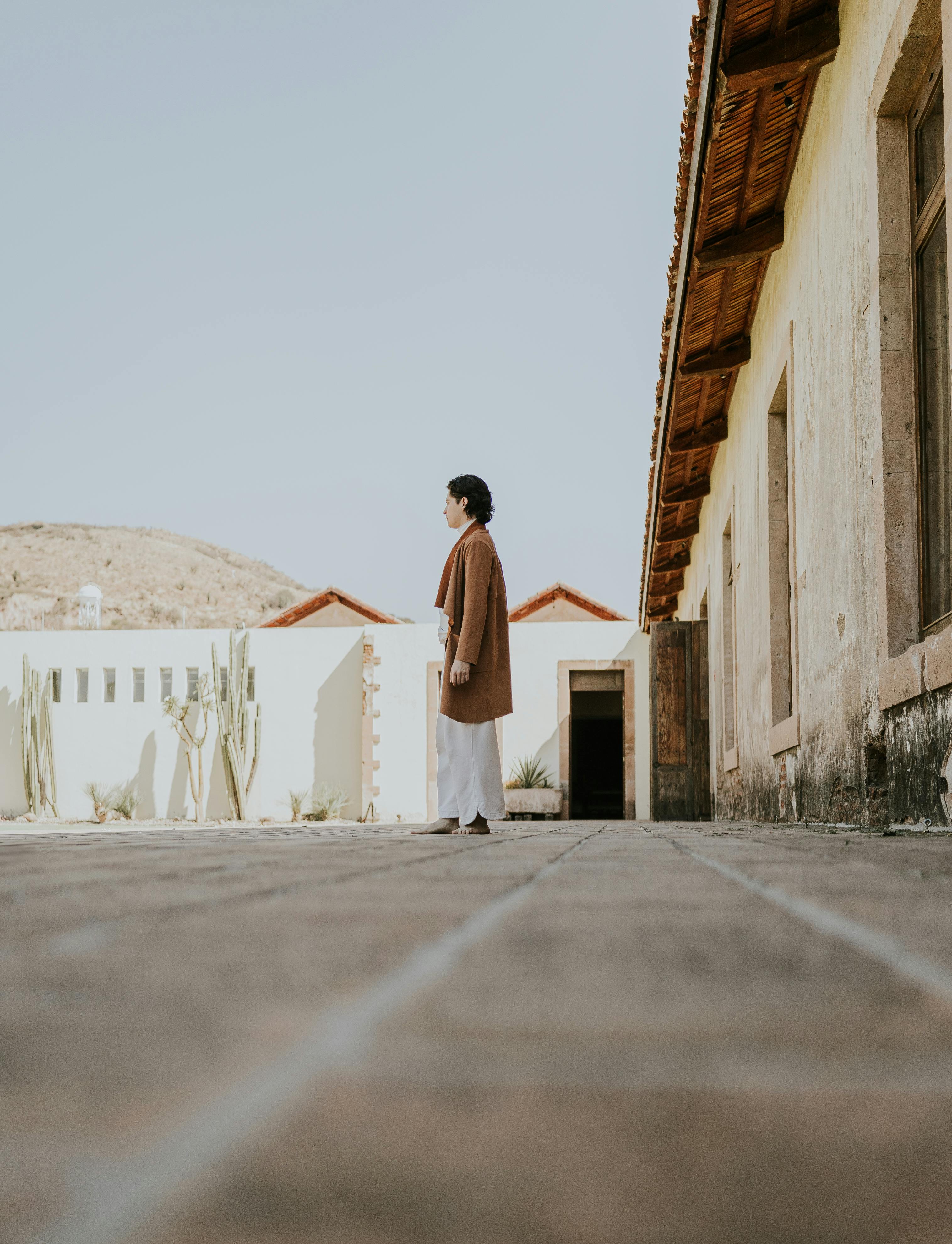 contemplative man in sunlit courtyard