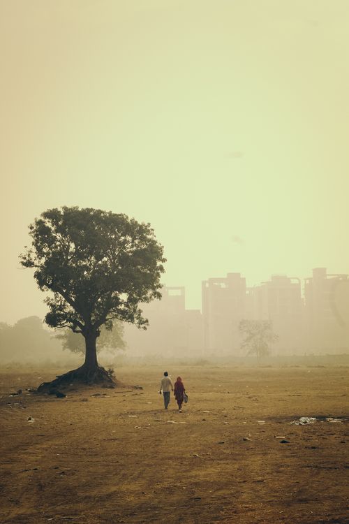 Free A serene morning walk under a golden sky in Navi Mumbai with misty atmosphere and urban backdrop. Stock Photo