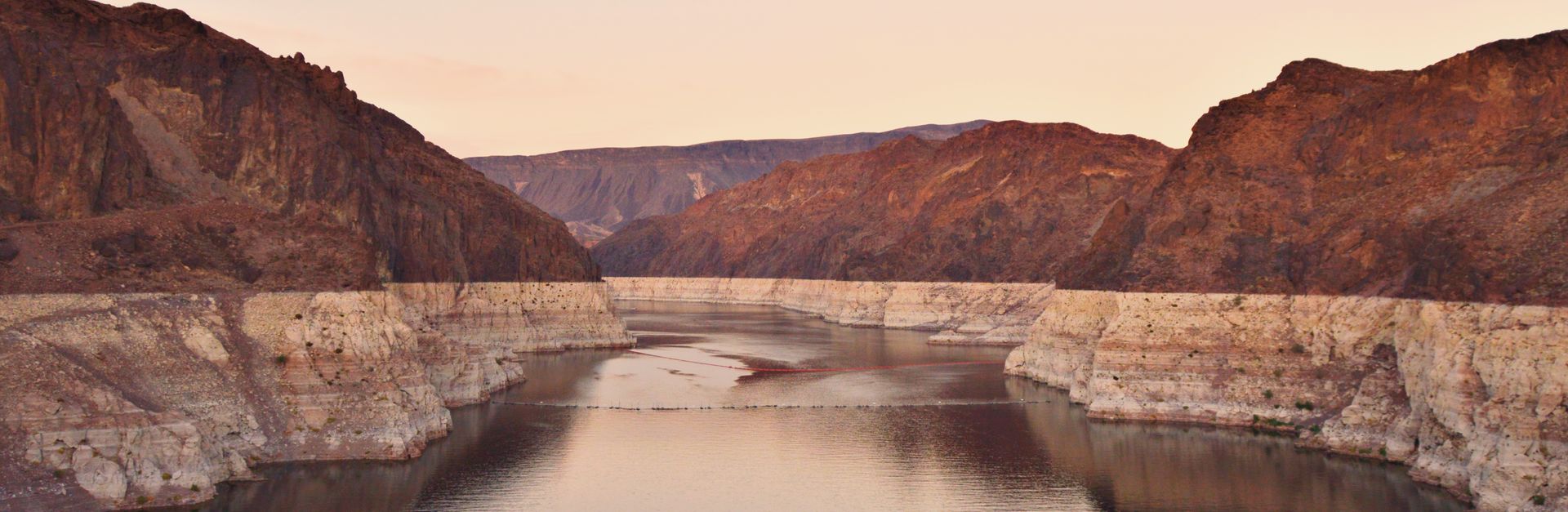 A stunning view of Lake Mead at sunset, showcasing the rocky desert landscape in Boulder City, Nevad