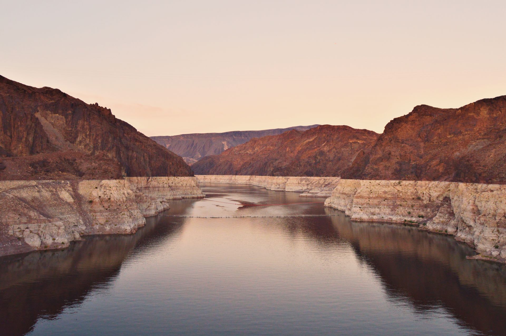 A stunning view of Lake Mead at sunset, showcasing the rocky desert landscape in Boulder City, Nevad