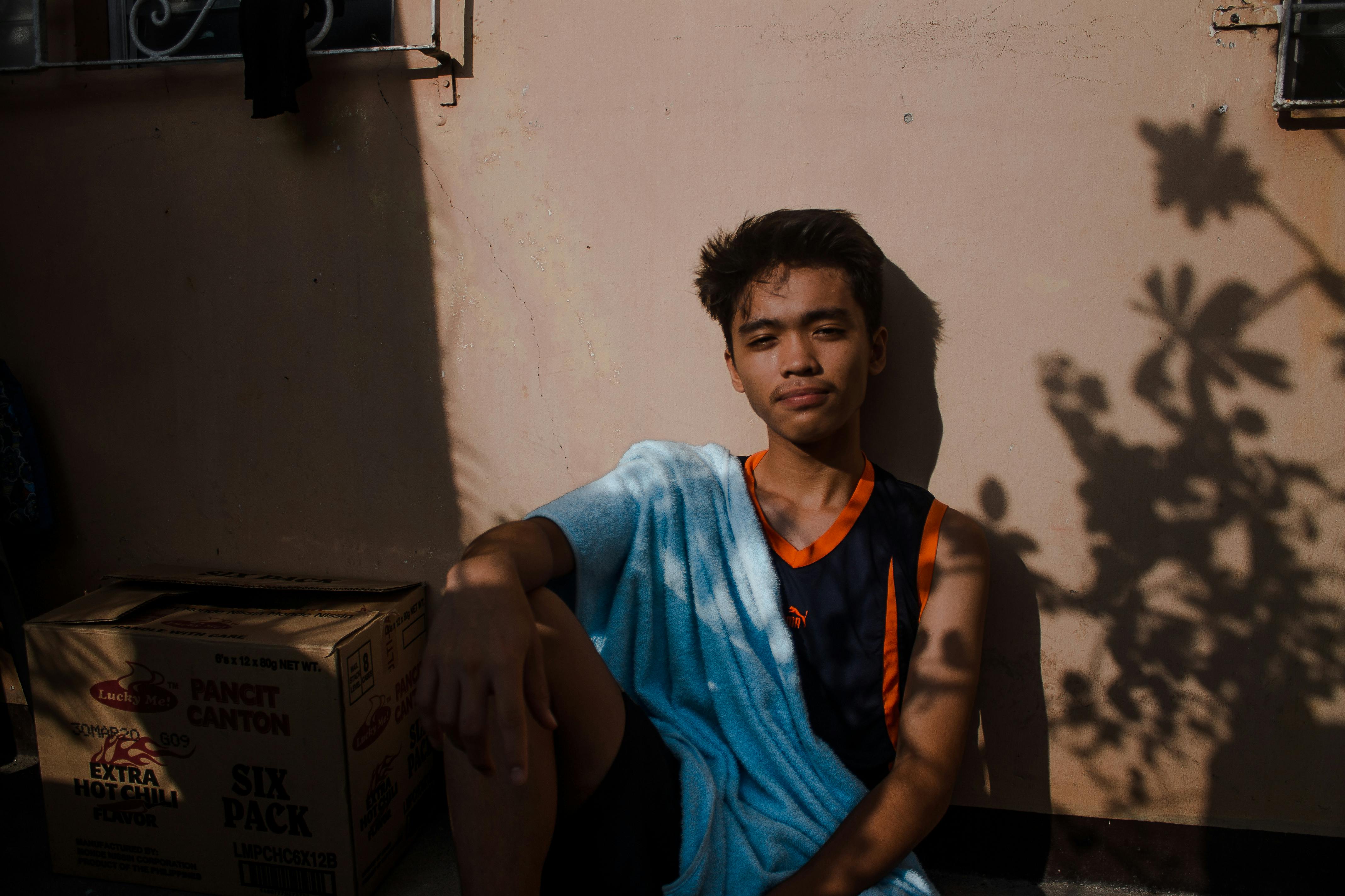 Portrait Of Hispanic Teenage Boy Leaning Against Wall 