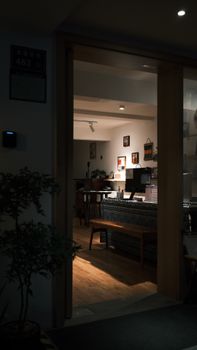 A warm, inviting indoor cafe with comfortable seating at night.