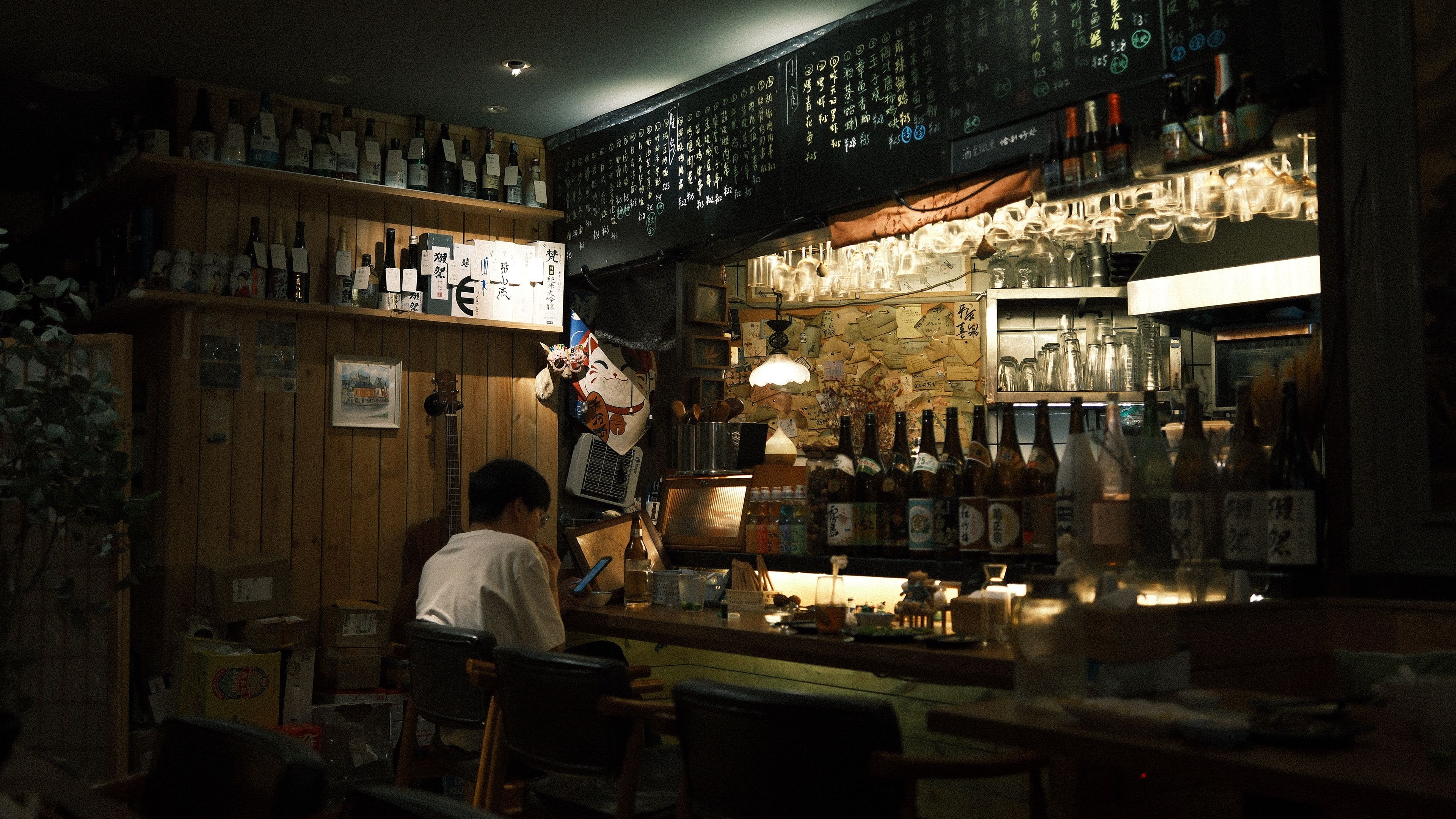 A local restaurant or bar decorated for an Eras Tour theme night, packed with fans in costumes