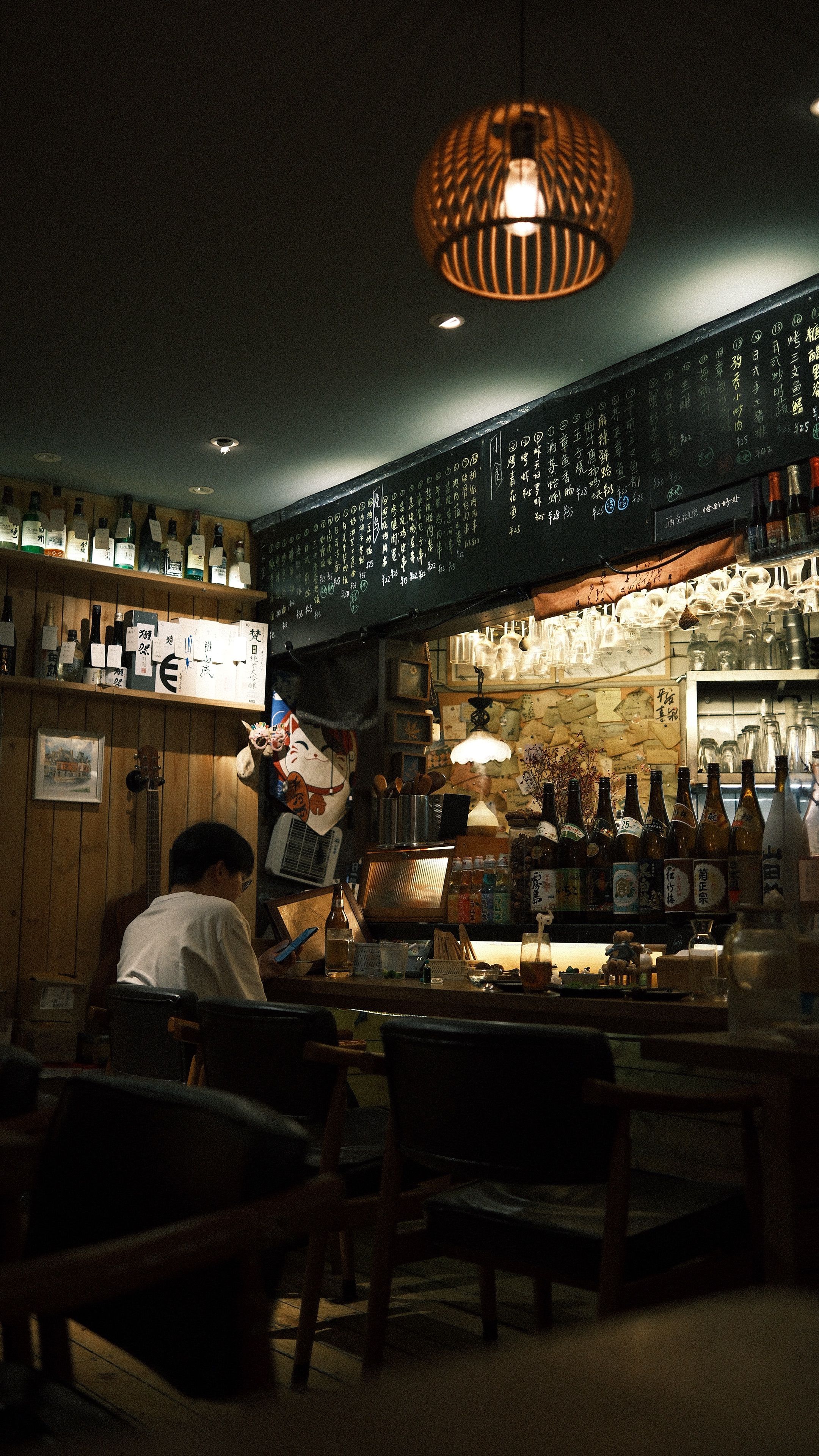 Warm interior of a traditional Japanese izakaya with wooden counter