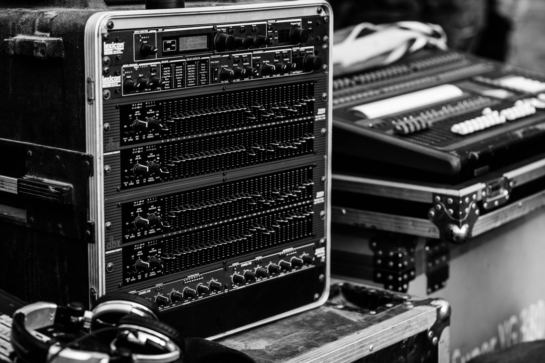 Black and white photo of professional audio equipment, emphasizing musical production.